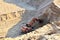 Excavator with large bucket in working in a opencast quarry