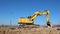 An excavator levels the ground in the opening of a new industrial development site