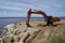 The excavator levels the sandy bank of the Volga River. Ulyanovsk. Russia