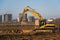 Excavator load the sand to the dump truck on construction site. Backhoe digs the ground for the foundation and construction