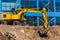 Excavator loader and dump truck during earthworks at a construction site. Loading land in the back of a heavy truck.