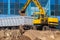 Excavator loader and dump truck during earthworks at a construction site. Loading land in the back of a heavy truck.