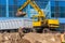 Excavator loader and dump truck during earthworks at a construction site. Loading land in the back of a heavy truck.