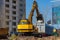 Excavator loader and dump truck during earthworks at a construction site. Loading land in the back of a heavy truck.