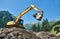 Excavator loader machine at construction earthmoving work in mountains