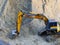 Excavator Loader with rised backhoe standing in sand