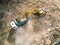 excavator loading debris of a destroyed building in truck. aerial view of demolition site