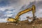 Excavator loading earth to perform works of settlement of a road