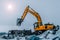 Excavator is loading excavation to the truck. Excavators are heavy construction equipment consisting of a boom, dipper or stick