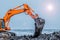 Excavator is loading excavation to the truck. Excavators hydraulic are heavy construction equipment consisting of a boom, dipper