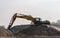 Excavator  loading sand in the truck