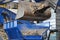 excavator loading trash, unrecognizable worker in a waste recycling plant is sorting waste