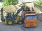 The excavator loads the dump truck with soil. Loading operations, road construction