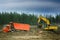 Excavator loads excess soil into dump trucks