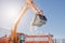 An excavator loads snow into a truck body