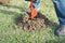 Excavator machine digging hole into grass