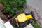 Excavator machine and workers digging dirt in the backyard