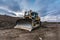 Excavator making earth movements for the construction of a road