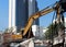 Excavator-mounted hydraulic jackhammer on construction site