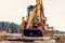 The excavator moves the concrete slabs to set the road in private territory