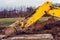 The excavator moves the concrete slabs to set the road in private territory