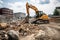 excavator moving large rocks and debris in construction site