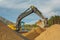 Excavator moving sand