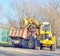 Excavator pouring stones into a truck