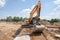 excavator prepares the construction site for the placement of concrete columns