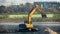 Excavator in the process of leveling the slope of the road