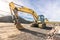 Excavator in a quarry extracting stone