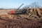 Excavator in the red clay quarry