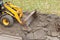 Excavator removes the old asphalt