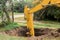 The excavator`s hydraulic piston digs deep into the pit with a industrial bucket on the construction site