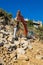 Excavator with shovel standing on hill with rocks