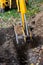 The excavator shovels earth with clay from the pit with a bucket for the construction of a septic tank. Ground work of the machine