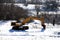 Excavator standing in a snow