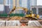 An excavator stands on heaps of soil during the construction of a road in a residential quarter of the city, against the