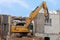 Excavator storms old house