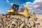 Excavator surrounded by granite rock to transform into gravel