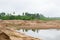 excavator and tractor at sandpit with water during earthmoving works