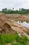 excavator and tractor at sandpit with water during earthmoving works