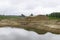 excavator and tractor at sandpit with water during earthmoving works