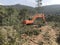 Excavator uproots stumps of cutted trees in the coniferous highland forest