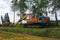 The excavator uproots trees to expand agricultural fields. The bulldozer harms the environment as a result of human activity.