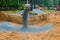 The excavator wheel during backfilling around the foundation of the building