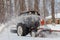 Excavator on a winter day. The tractor removes snow from the road