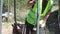 Excavator woman  with yellow warning vest wearing dismount on an excavator