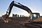 Excavator working at construction site. Backhoe during earthworks. Digging ground for the foundation and for laying sewer pipes