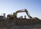 Excavator working at construction site. Backhoe during earthworks. Digging ground for the foundation and for laying sewer pipes